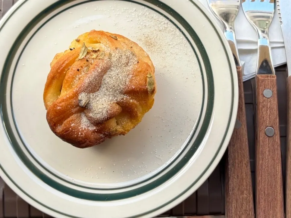 Cross-section of the cardamom bun with a latte