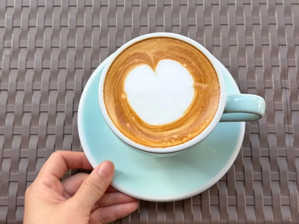 Terrace table with a decaf latte being enjoyed