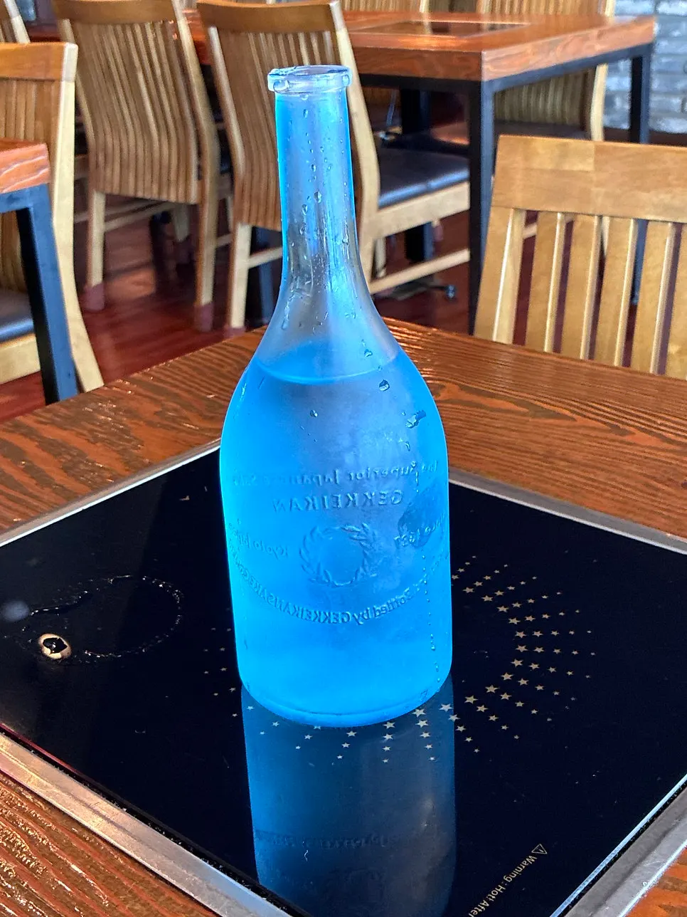 Chilled water served in a glass bottle