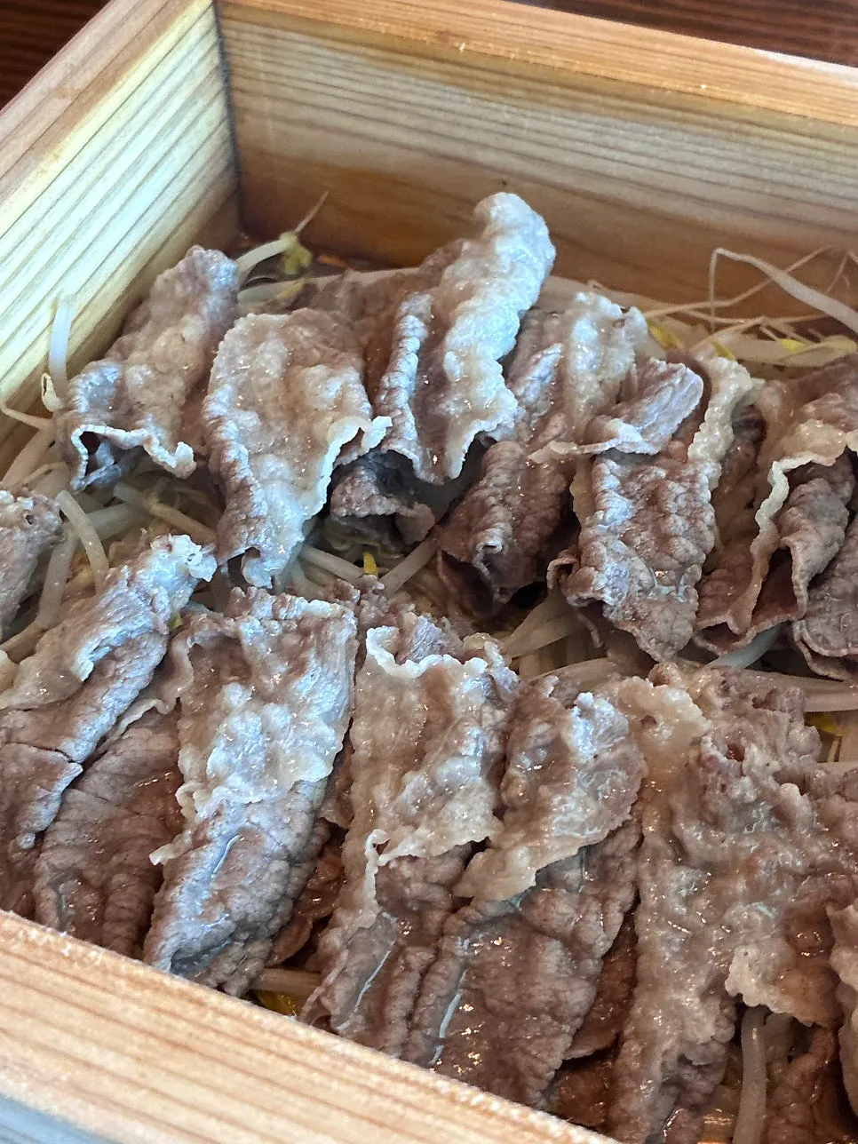 Beef brisket hoban-jjim placed over bean sprouts