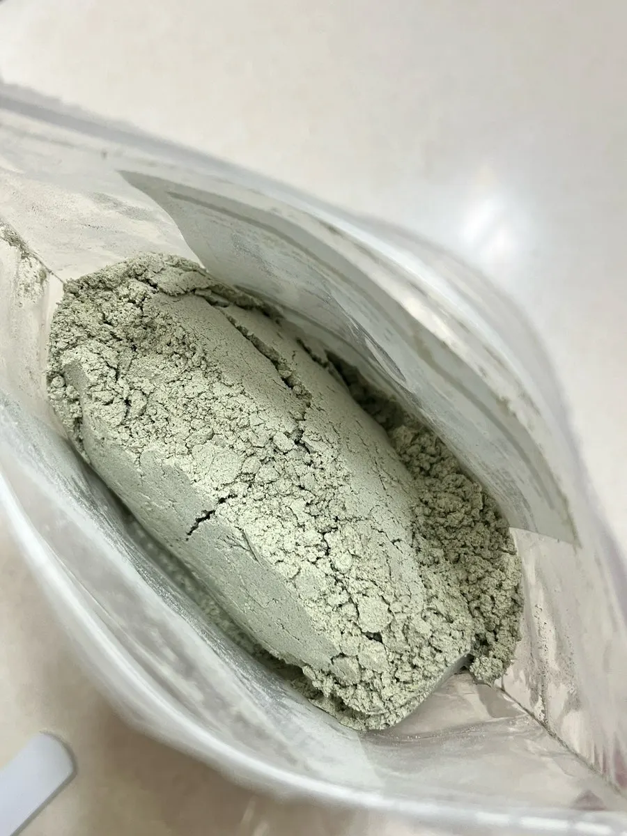 Mugwort-colored soy milk powder scooped into a cup