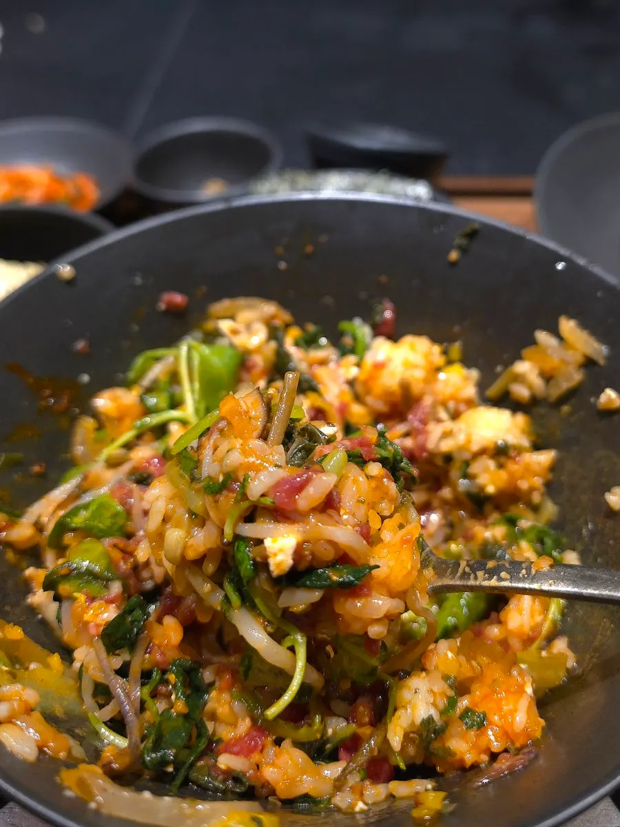 Yukhoe bibimbap mixed with a spoonful of doenjang jjigae