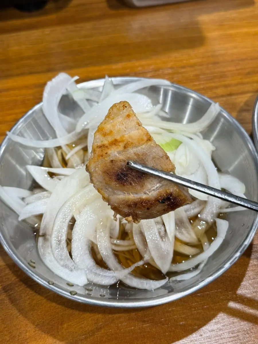 Meat wrap eaten with pickled onions