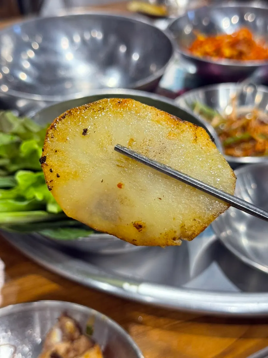 A wrapped bite of meat and lettuce