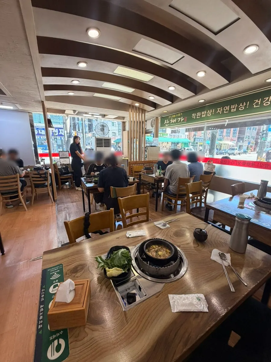 Dining hall with generously spaced tables at Sanchaega Hanjeongsik