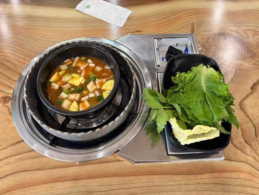 Basic doenjang jjigae and lettuce wraps served first