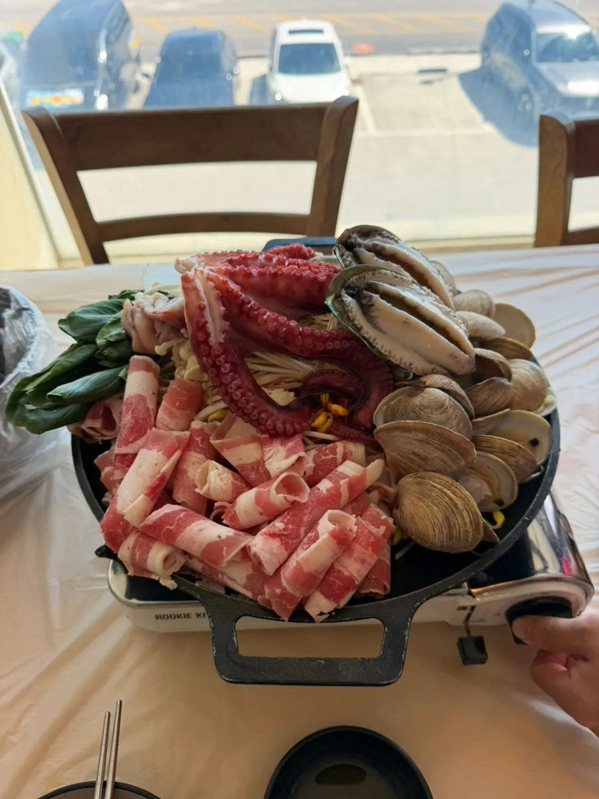 Griddle topped with whole octopus and seafood