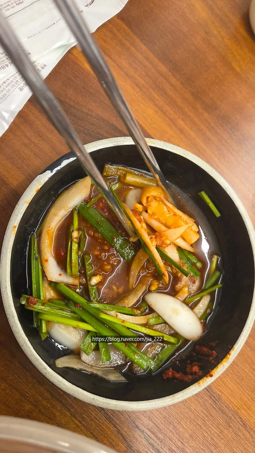부추를 듬뿍 얹은 닭고기 한 점