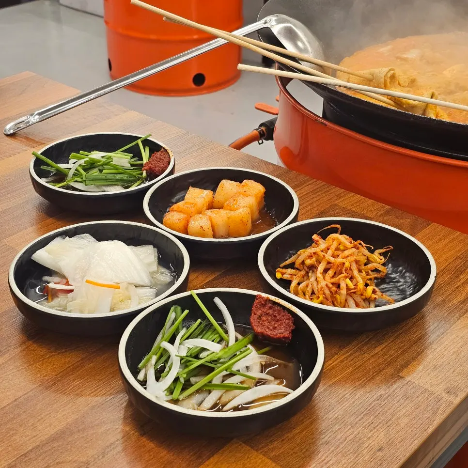 Basic side dishes of kimchi, seasoned bean sprouts, white kimchi, and secret chive sauce