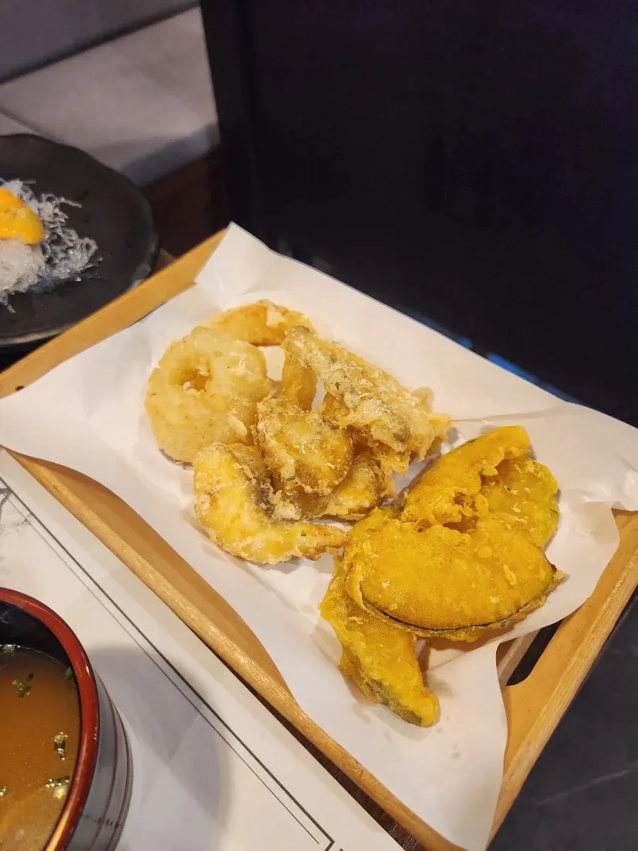 Simple banchan spread of vegetable porridge and hoe-muchim