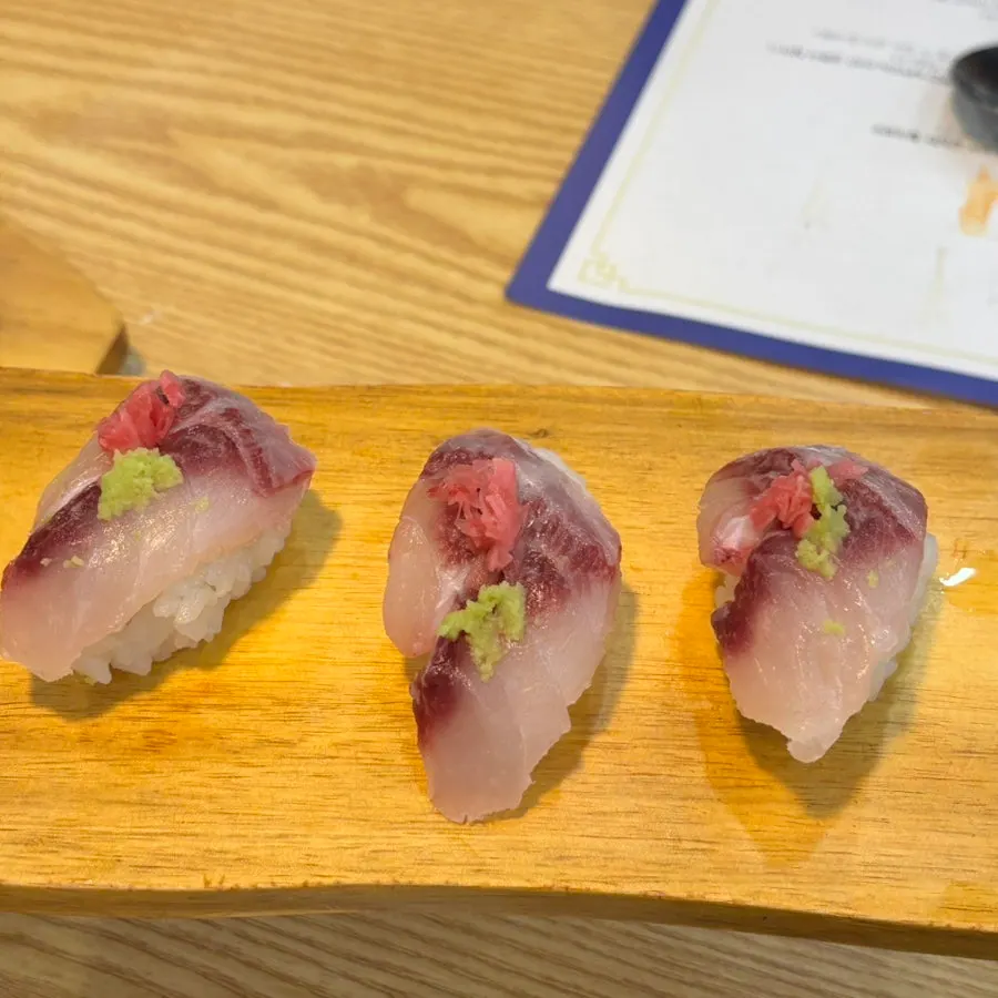 Sushi topped with ginger and wasabi