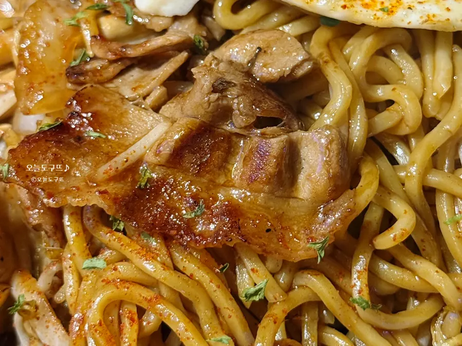 Noodles mixed with crisply grilled pork belly