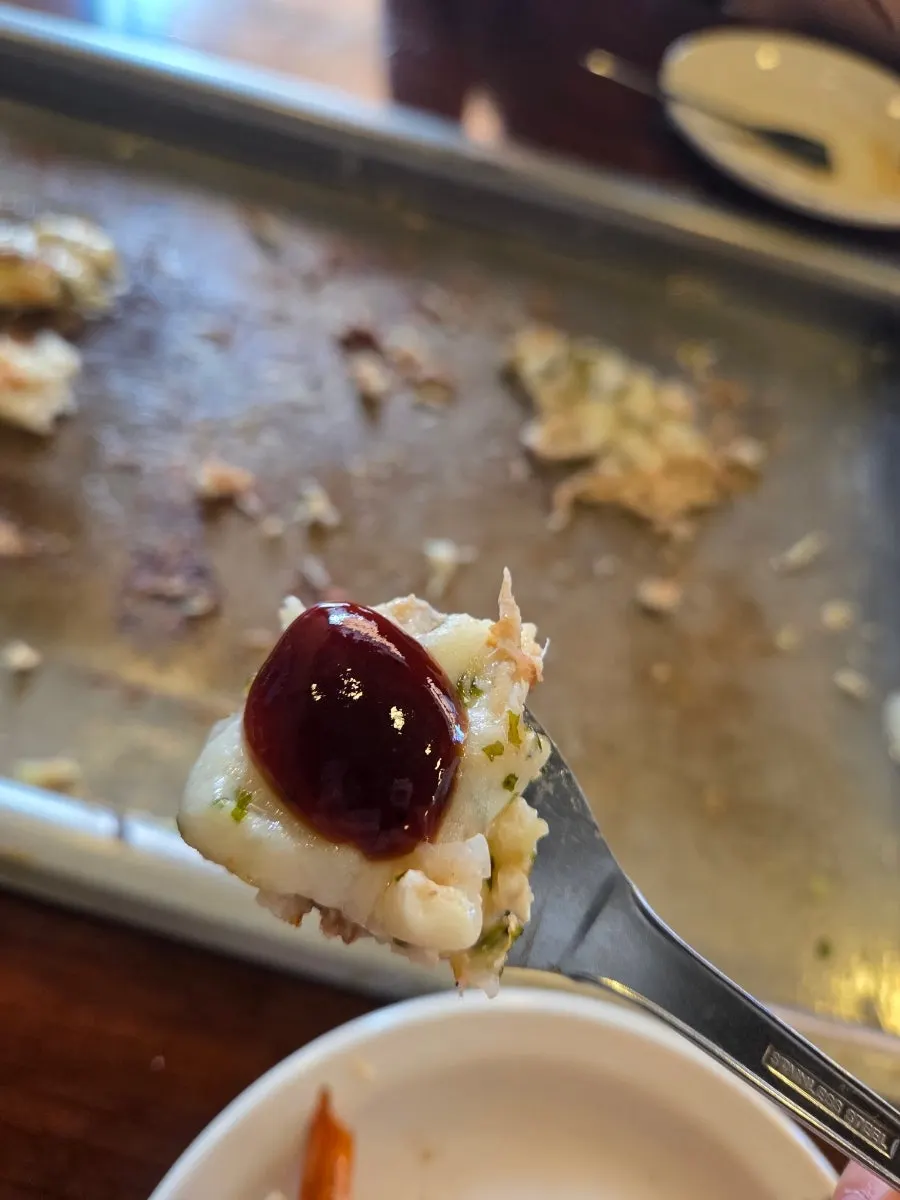 A spoonful of monjayaki topped with mochi