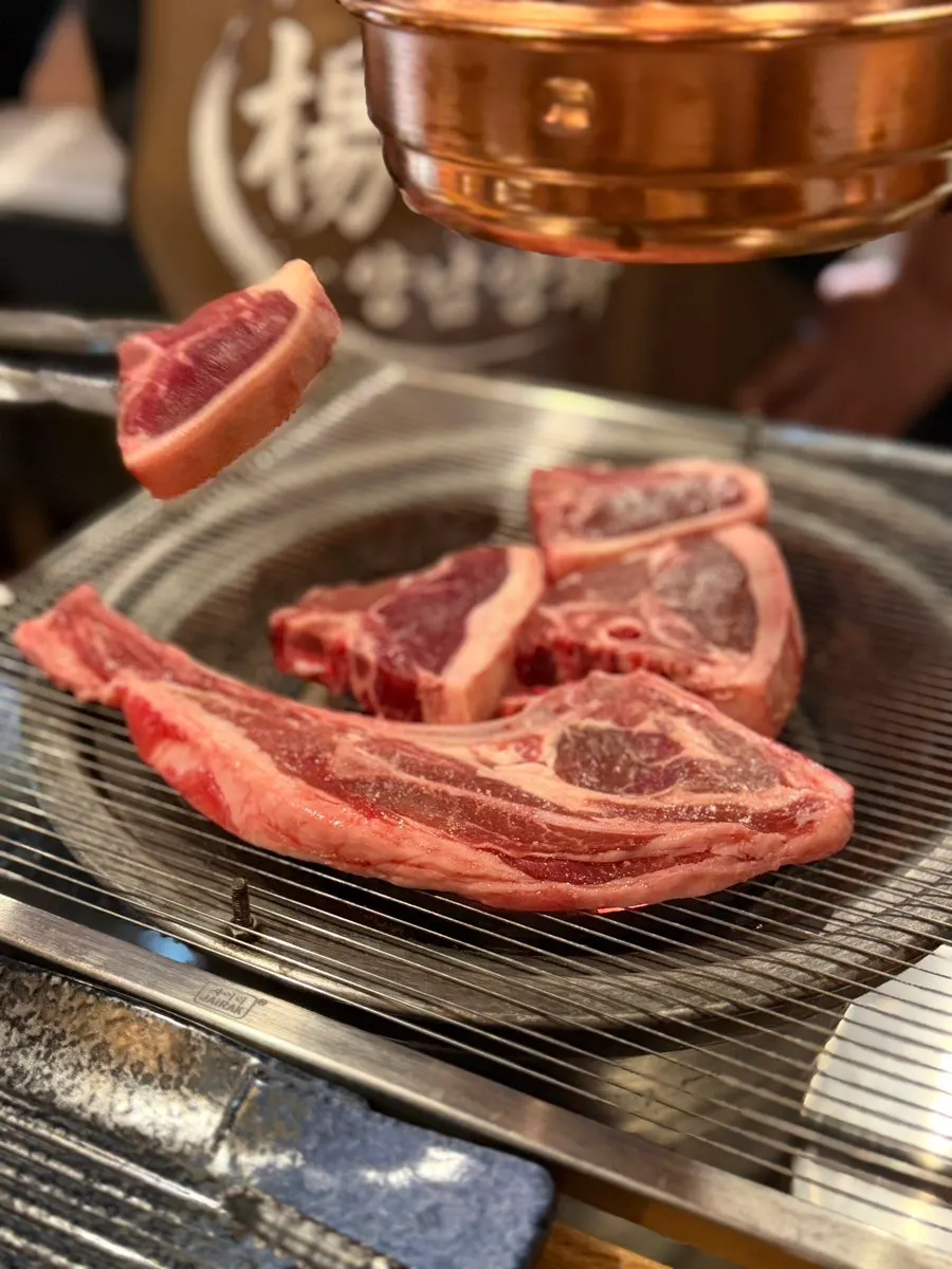 Premium lamb ribs grilling over the charcoal fire