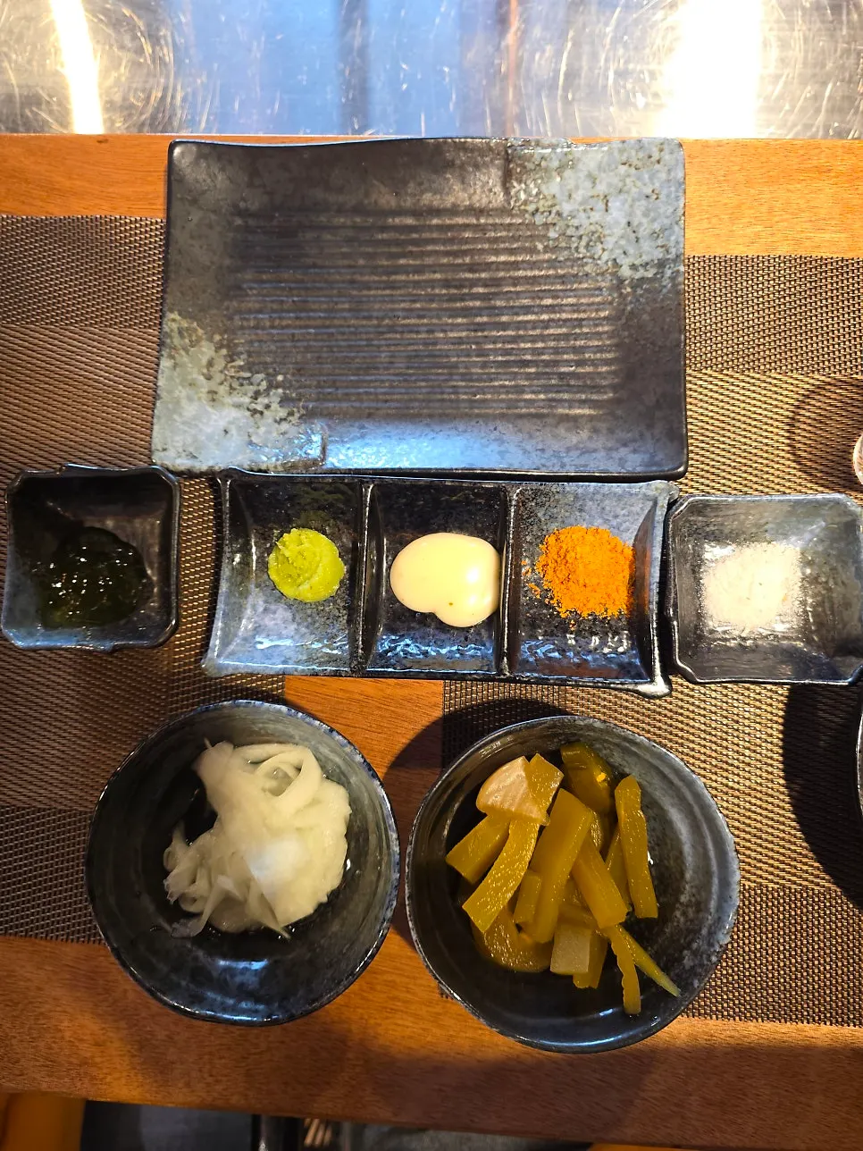 Lineup of sauces including Maldon salt, cumin, and basil jelly