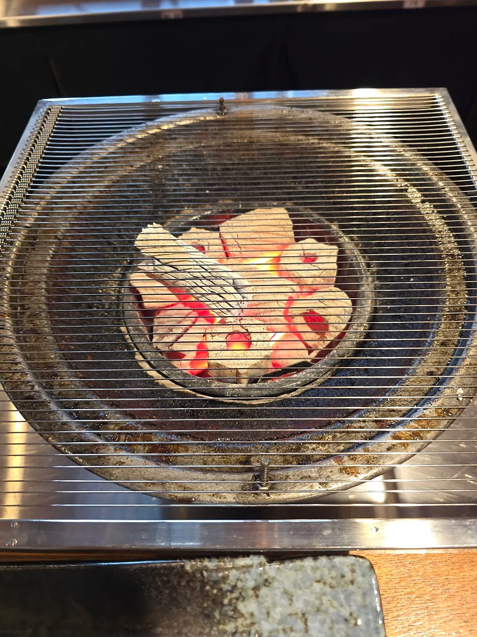 Glowing red charcoal filling the grill brazier