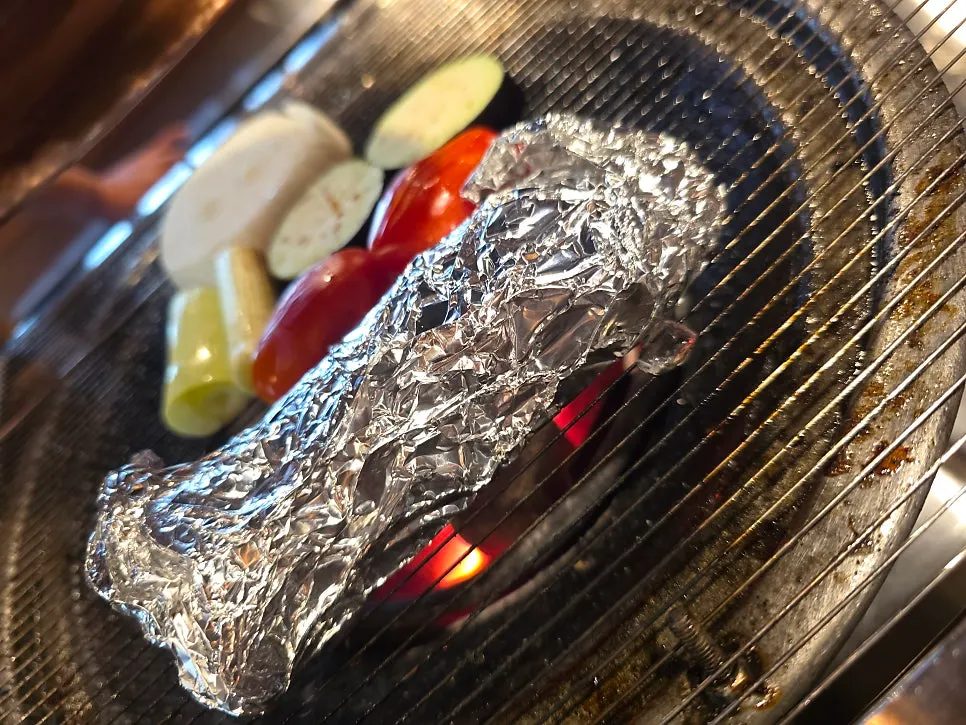 Staff member grilling the lamb to medium doneness