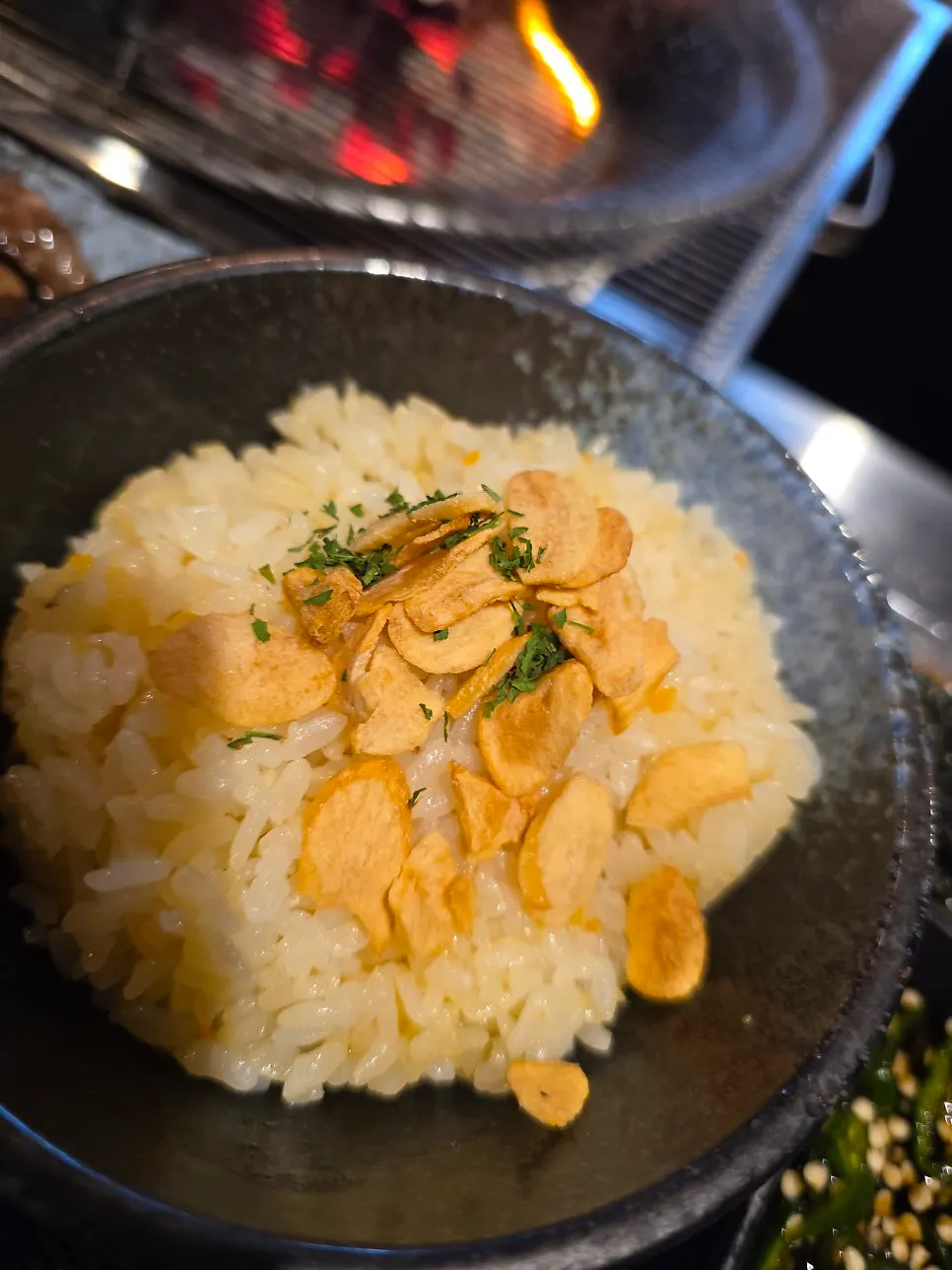 Garlic rice topped with garlic chips and parsley