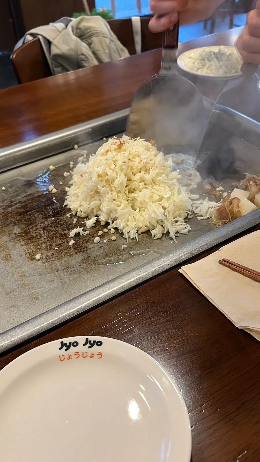 Mentaiko monjayaki being stir-fried on the grill