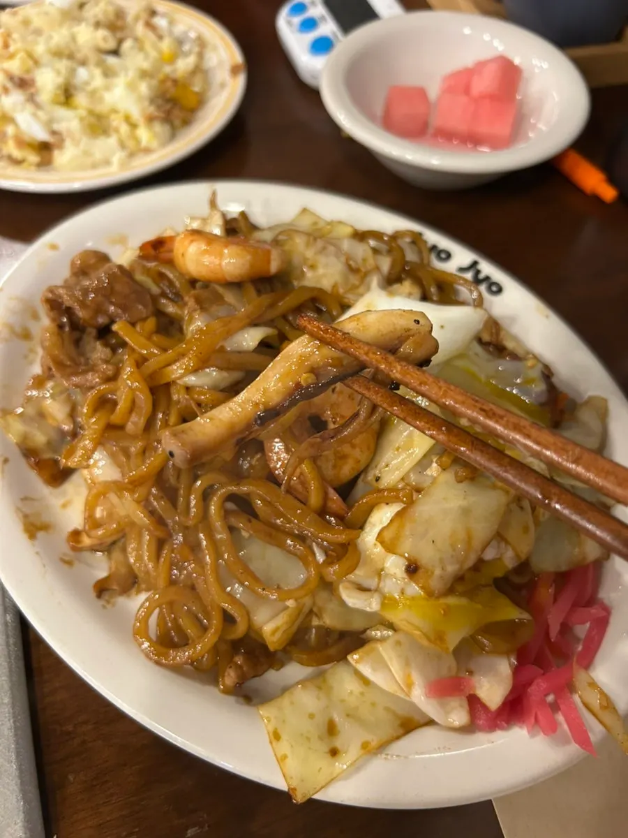 A bite of karai yakisoba lifted from the plate