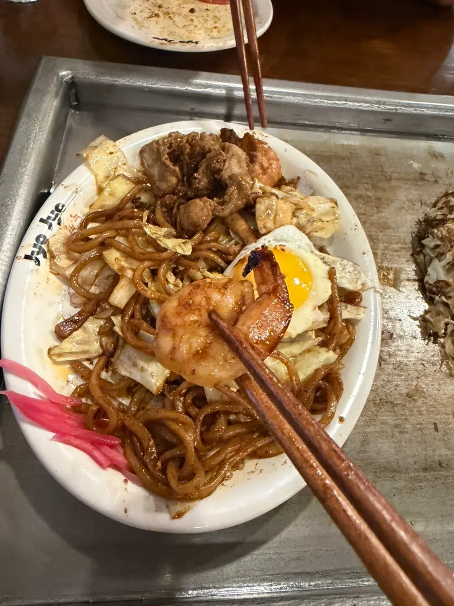 A bite of yakisoba with cabbage and shrimp mixed in