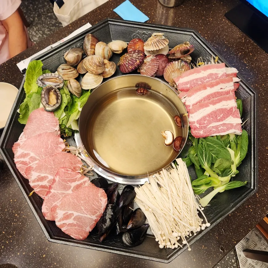 Two servings of Palmi Clam Shabu Kalguksu in the octagonal pot