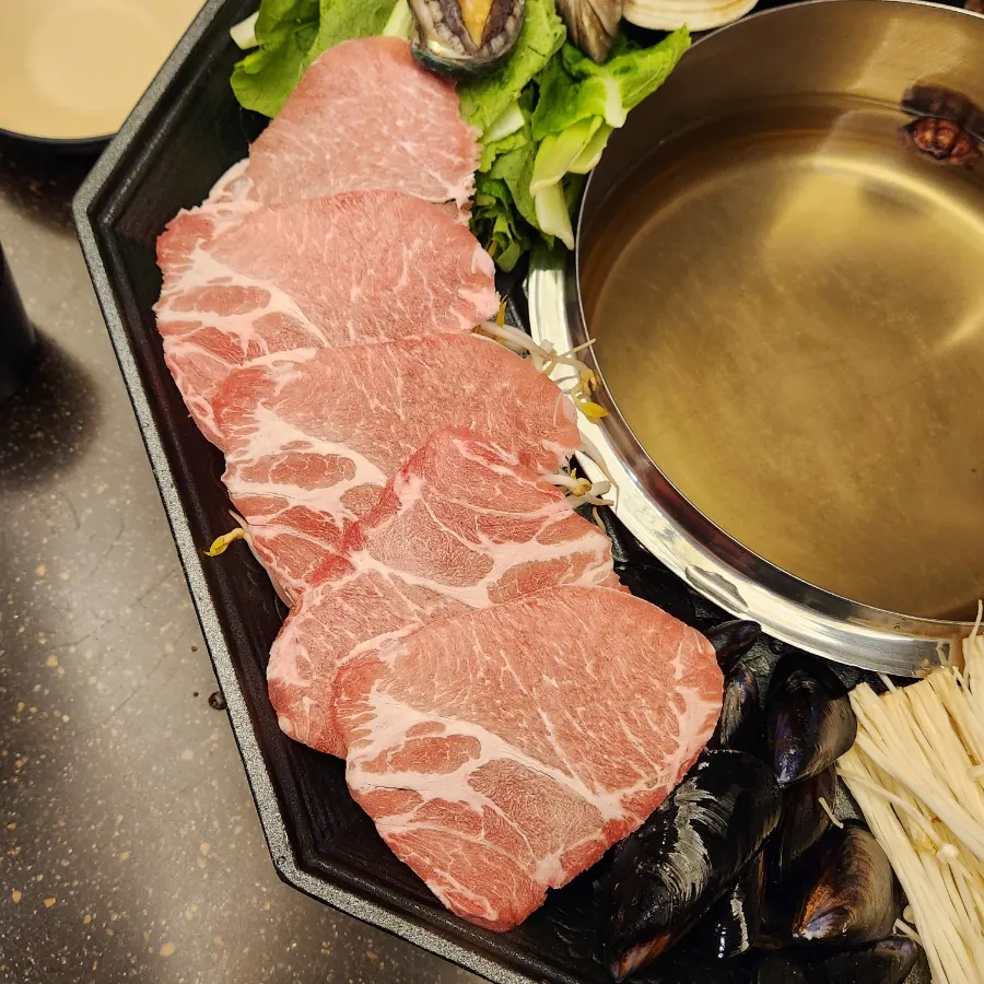A plate of shabu meat and vegetables