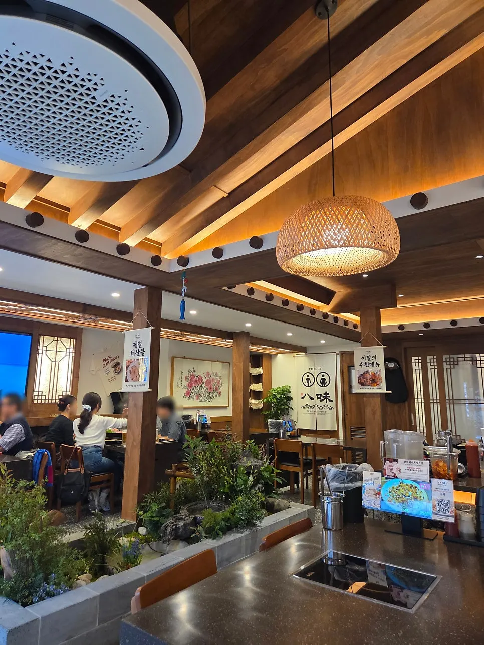 Restaurant interior decorated with wood tones and warm lighting
