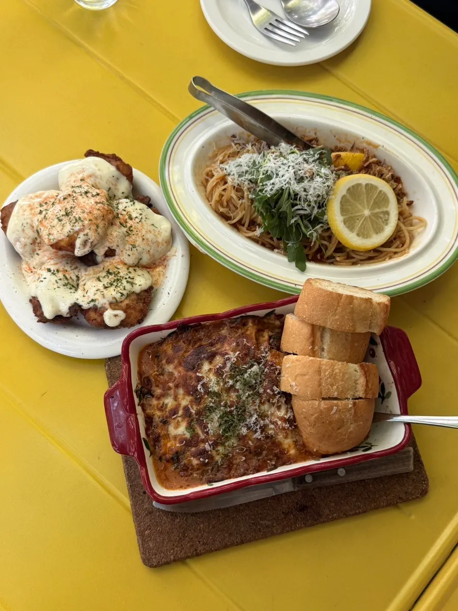 Four brunch dishes served on a yellow table at Meolmeol Pangyo