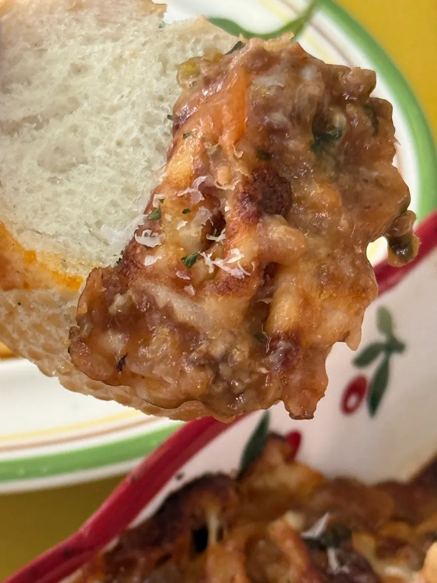Baguette topped with lasagna sauce