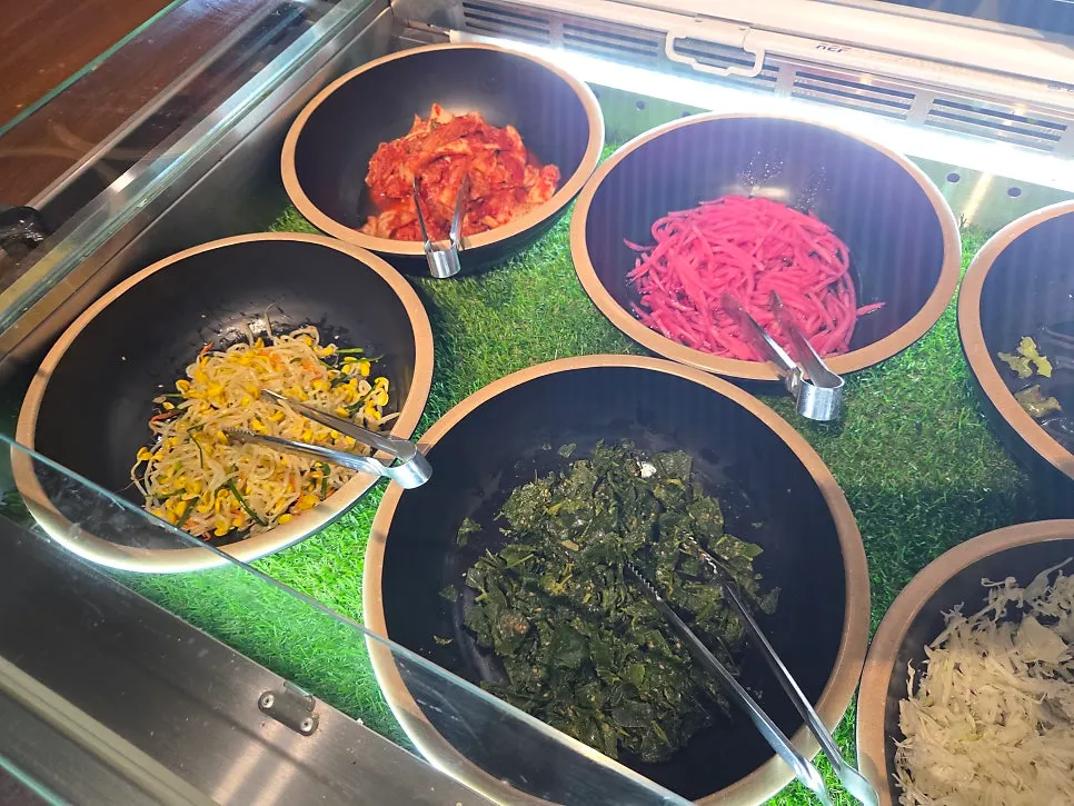 Homemade side dishes including seasoned bean sprouts and chwinamul