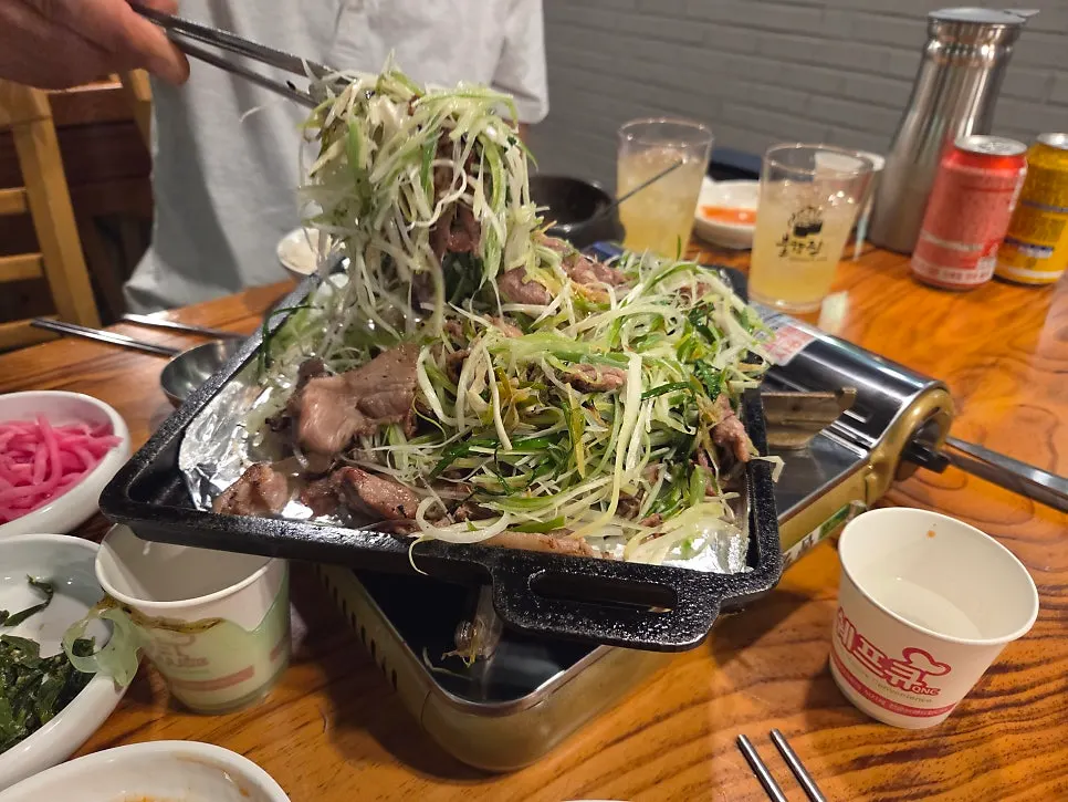 A bite of meat piled high with scallion shreds