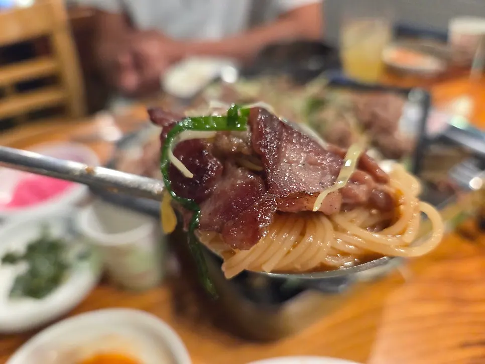 Bulgogi and scallion shreds piled on a wrap