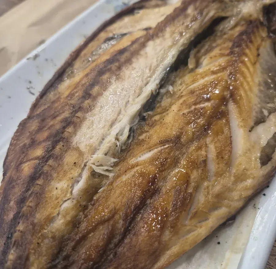 A whole wood-fired grilled mackerel