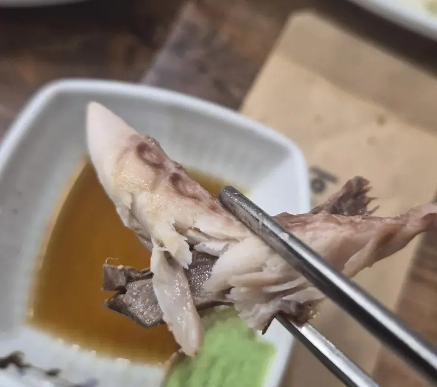 A piece of mackerel placed on top of hot pot rice