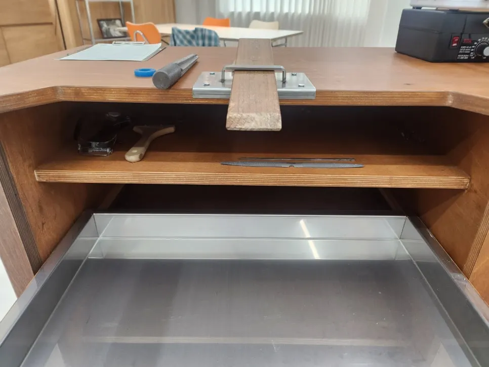 Work station set up with an apron on, ready to start wax carving