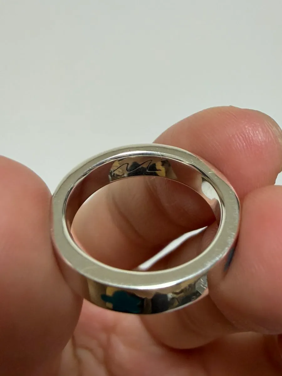 Handwritten signature engraving on the inside of the ring