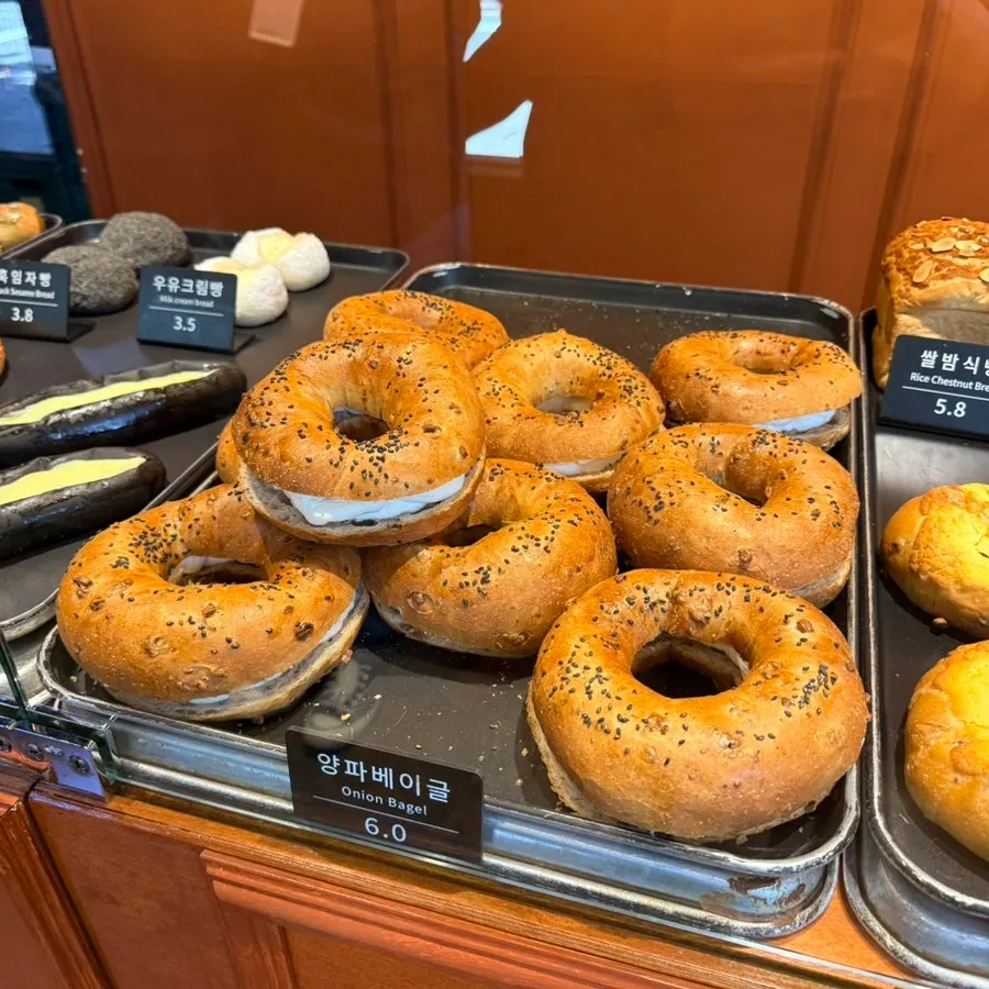 Cheese bread, squid ink condensed milk bread, milk cream bread, and black sesame bread on display