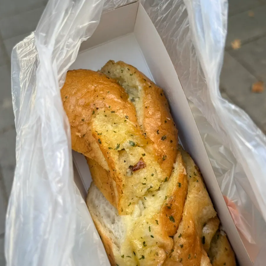 Rice-chestnut loaf and garlic bread in takeout bags