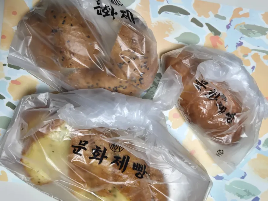 Garlic bread, onion bagel, and salt bread packed to go