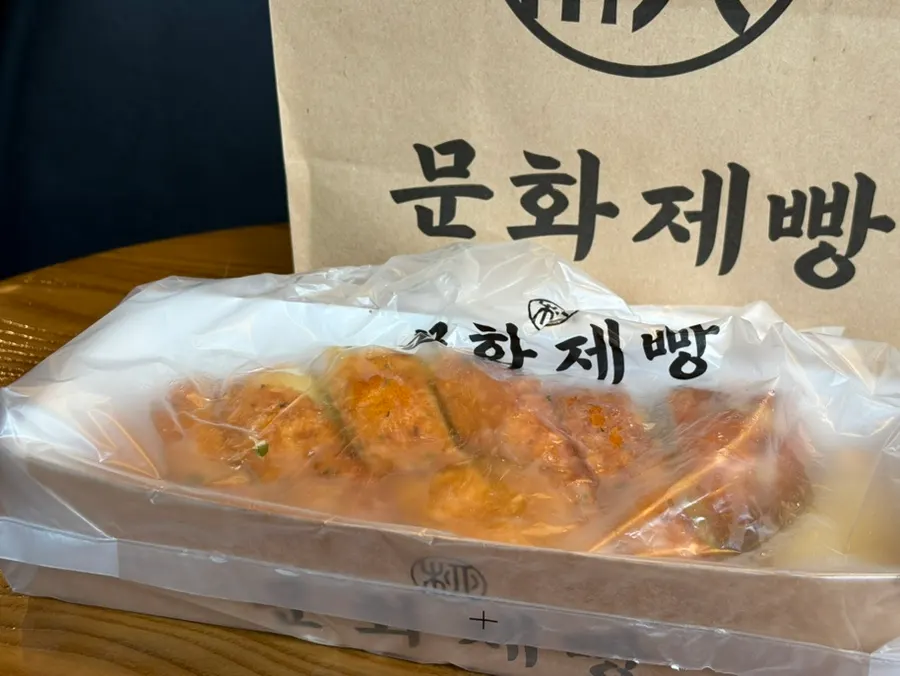 Munhwa Bakery's garlic bread and onion bagel wrapped in plastic
