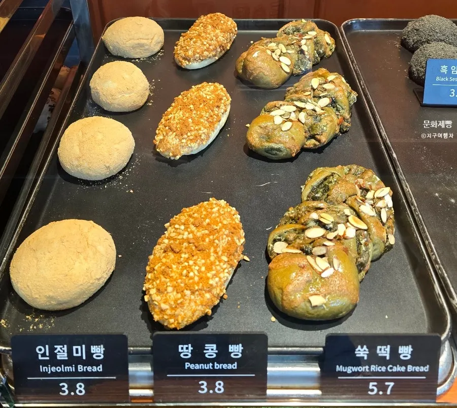 Bread arranged on a wooden display stand at Munhwa Bakery