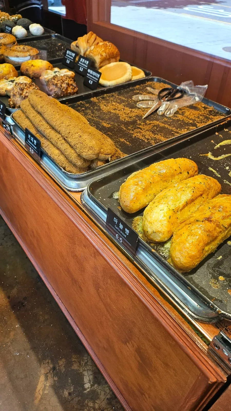 Sliced loaves and savory bread lineup at Munhwa Bakery