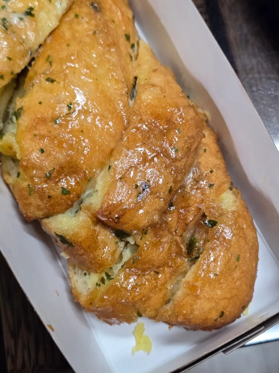 A piece of Munhwa Bakery's garlic baguette