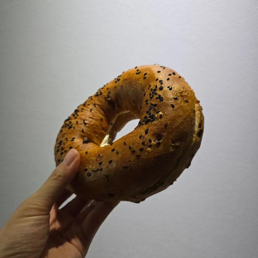 Cross-section of the onion bagel showing plenty of cream