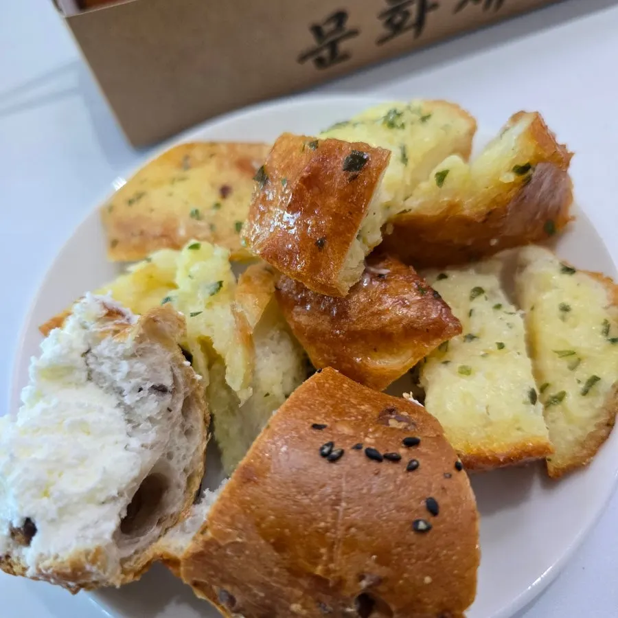 A piece of garlic baguette with noticeable garlic flavor