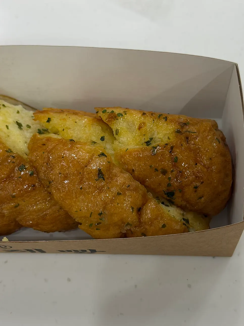 Garlic baguette cut into bite-sized pieces for takeout