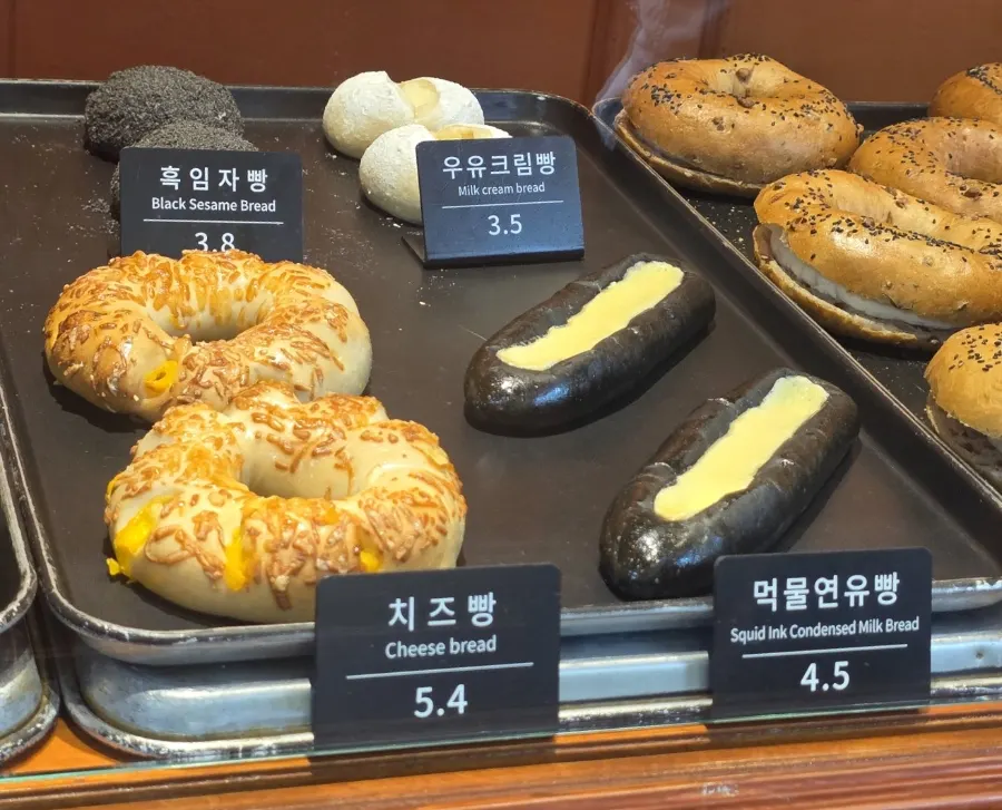 Rice-chestnut loaf and squid ink bread at the Munhwa Bakery counter