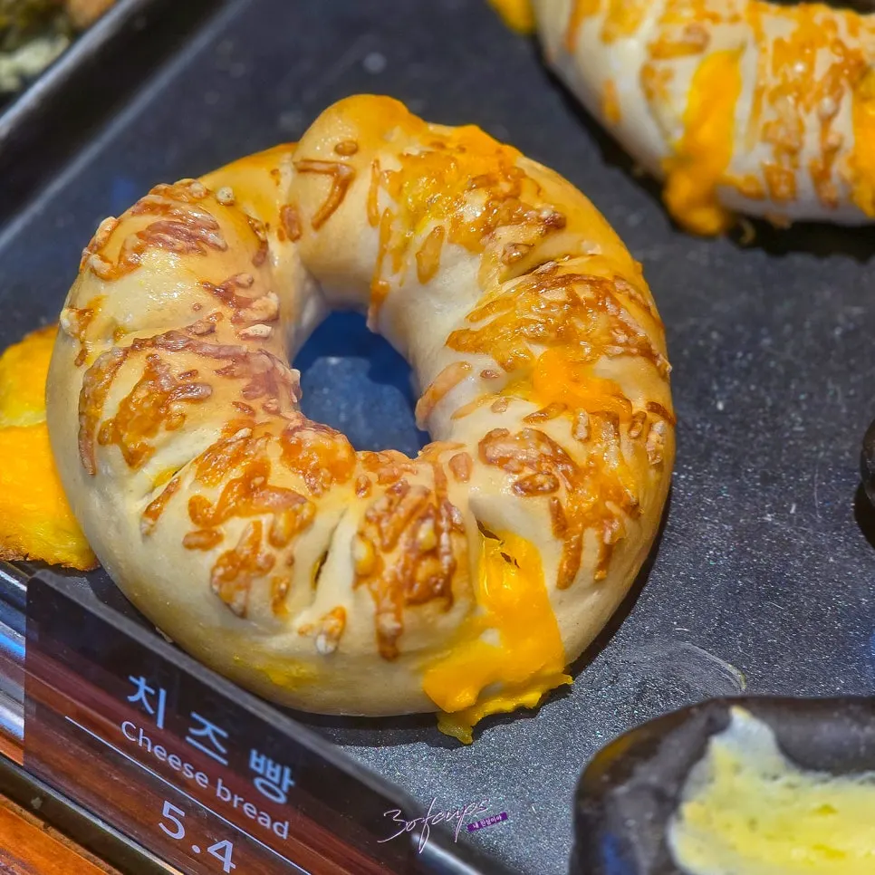 Cheese bread and squid ink condensed milk bread on display