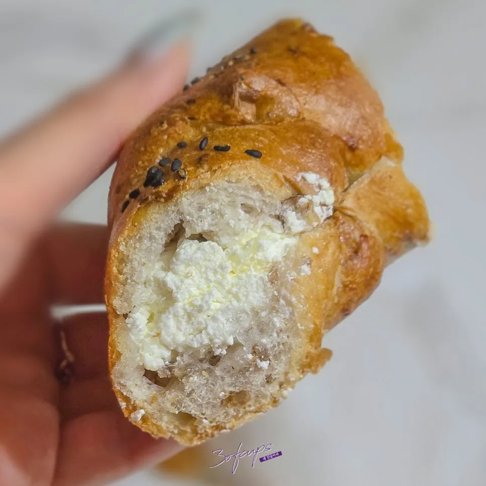 Cross-section of an onion bagel with onion cream cheese